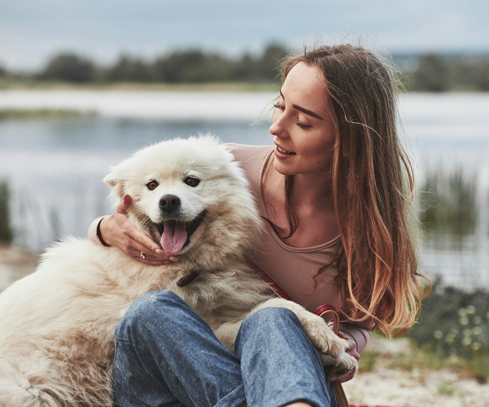 woman petting happy dog